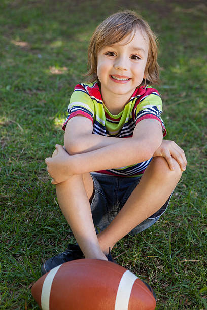 istock Little boy with american football 480923902