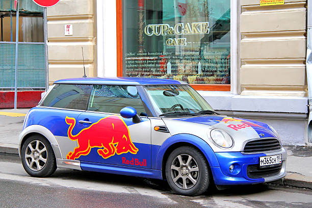 Austin Mini Cooper Moscow, Russia - June 3, 2012: Small car Austin Mini Cooper covered with the Red Bull advertisement parked at the city street. red bull mini stock pictures, royalty-free photos & images