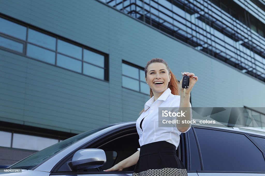 woman with car key happy woman holding car key and smiling.Nikon D3X / D800. Converted from RAW. Adult Stock Photo