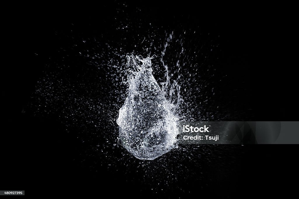 Water balloon Balloon bursting on black background. Exploding Stock Photo