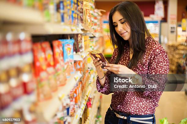 Looking At The Food Label Stock Photo - Download Image Now - Label, Supermarket, Reading