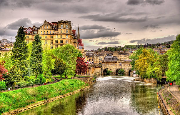 Pulteney Bridge over the River Avon in Bath, England View of Bath town over the River Avon - England bath england photos stock pictures, royalty-free photos & images