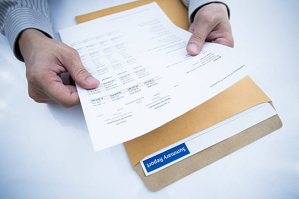 istock man hand with pen and business report 480928699