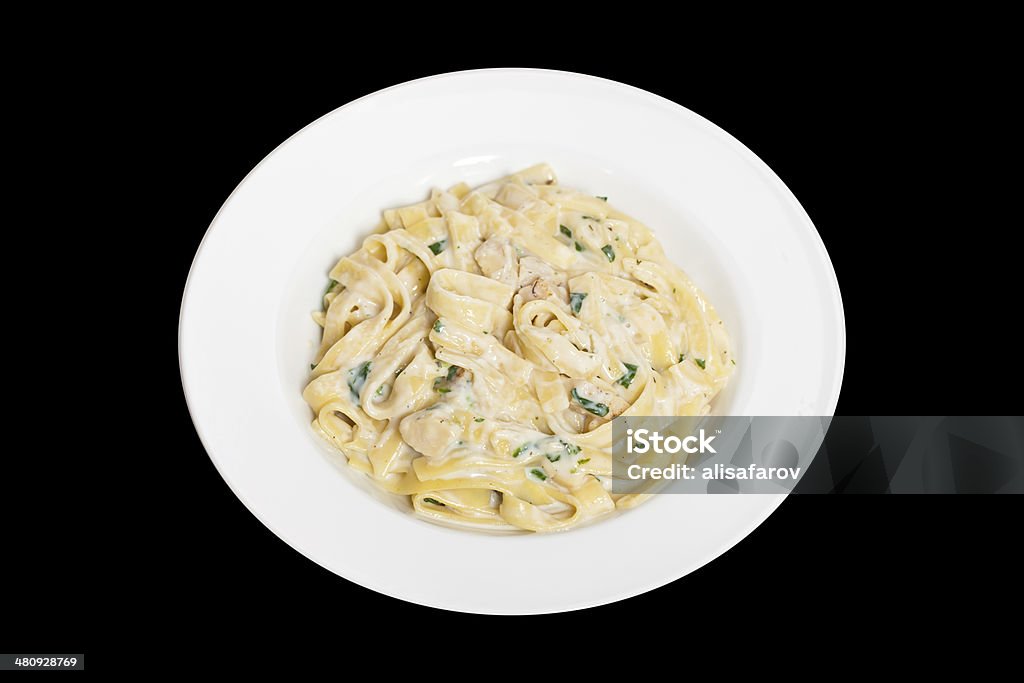 Chicken fettuccine alfredo Chicken creamy alfredo sauce with white meat chicken, spinach & fettuccine pasta. Selective focus. Appetizer Stock Photo