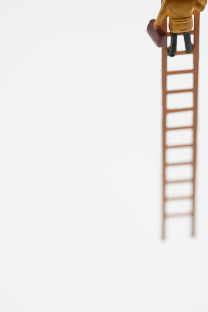 istock Businessman figurine climbing ladder, low section 480929547
