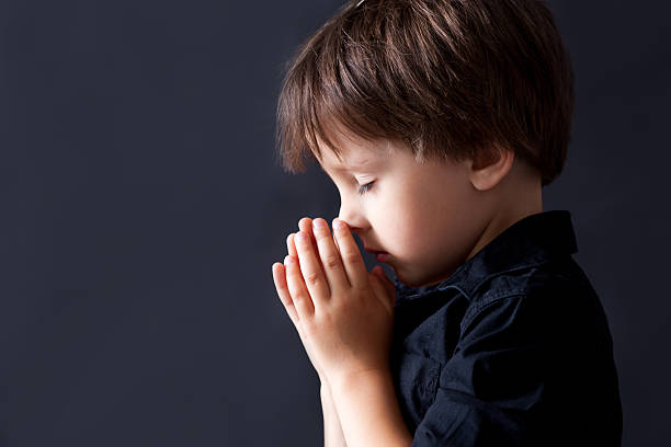 istock Little boy praying, child praying, isolated background 480932696