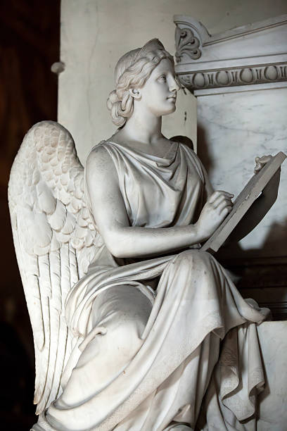 A marble statue of an angel holding a font at the entrance of the church of San Giuseppe dei Teatini, a masterwork of neoclassic.