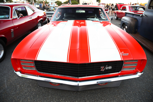 Woodside, Nova Scotia, Сanada - August 8, 2013: Front end, wide angle view of a Chevrolet Camaro Z/28 parked in parking lot in Woodside, Nova Scotia during weekly automotive enthusiast gathering. Other cars and people can be seen in the background