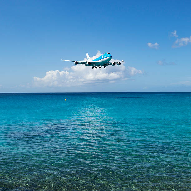 Maho Bay, St Maarten, Netherlands Antilles - November 15, 2013: A KLM Boeing 747 comes in for a landing at Princess Juliana International Airport in St. Maarten.