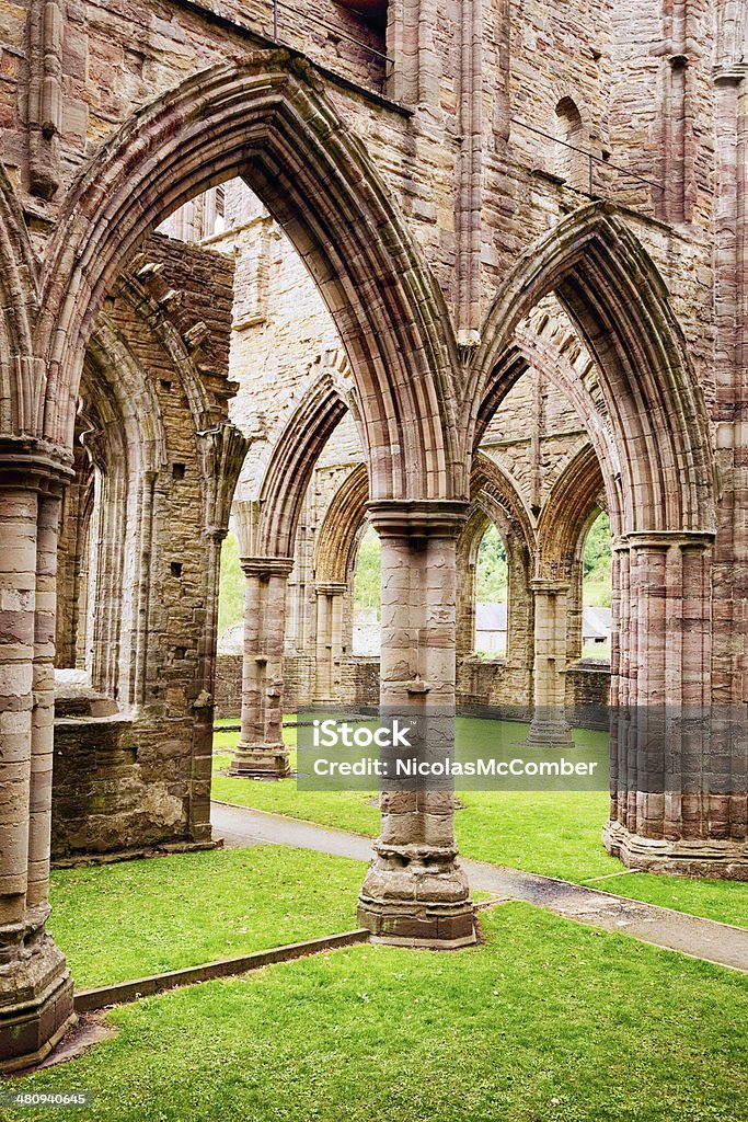 Tintern abbey ruins gothic arches Tintern abbey ruins gothic arches and lawn in Wales, UK. Abbey - Monastery Stock Photo