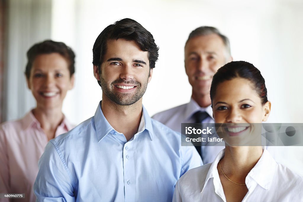 We are a great team! A group of corporate co workers standing alongside each other Adult Stock Photo