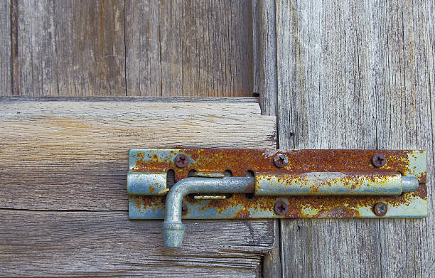 istock rusty old bolts on the wooden door 480946088