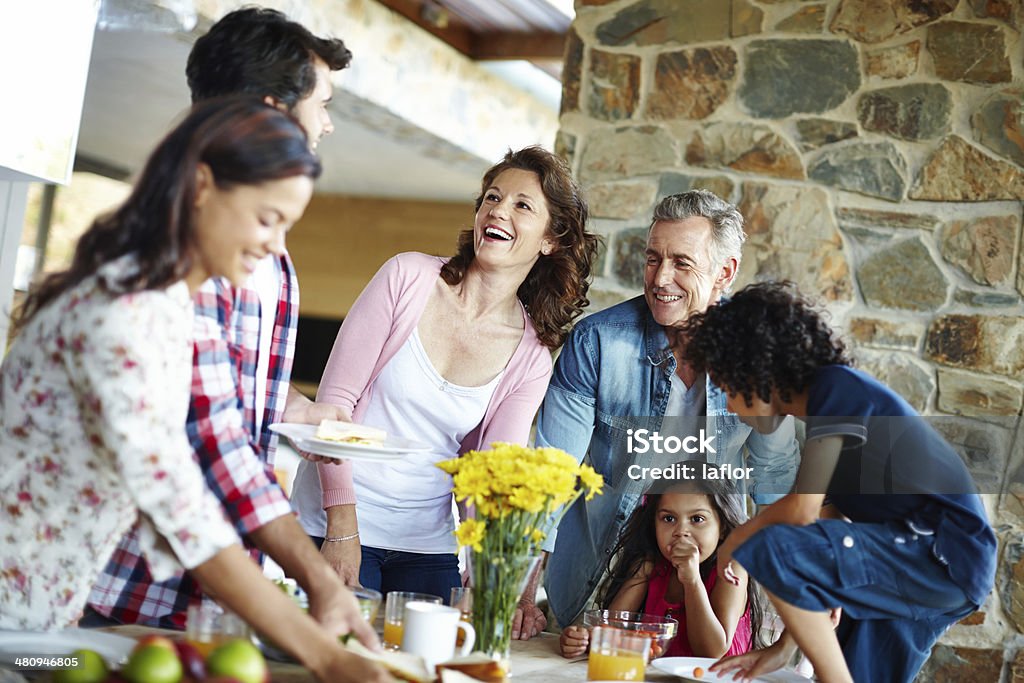 It's time to eat! A happy family enjoying a meal time together Adult Stock Photo