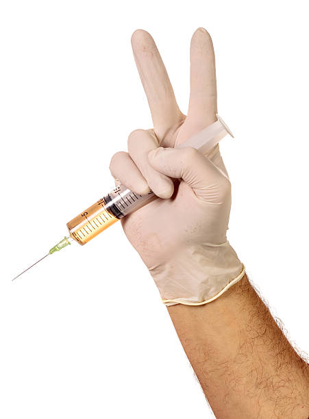 Hand holding medical needle stock photo