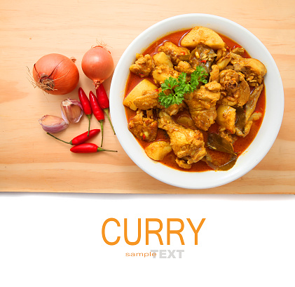 Curry Chicken with ingredients on the wooden table background