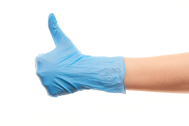médico as mãos em luvas cirúrgicas azul mostrando os polegares para cima o sinal - close to moving up closed women imagens e fotografias de stock