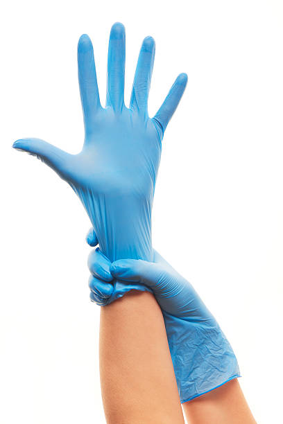 istock Female doctor's hands putting on blue sterilized surgical gloves 480948454