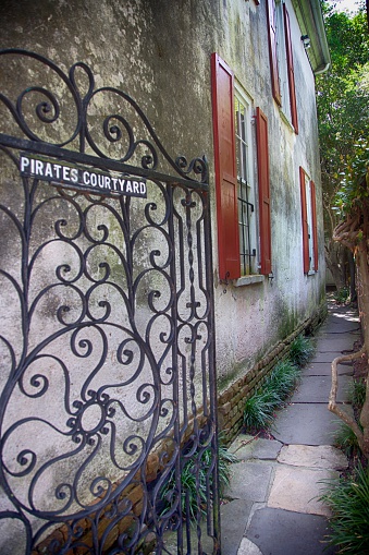 Open gate beckons passerby's down the narrow alley.  One of the many off the beaten path detours throughout the city of Charleston, SC.