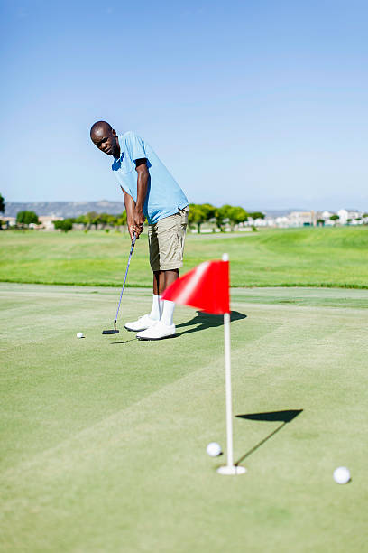 istock African golfer practicing his putting skills on the golf course 480954041