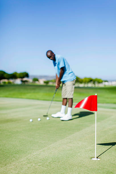 istock African golfer practicing his putting skills on the golf course 480954071