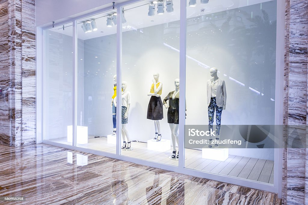 mannequins in fashion shop display window Store Window Stock Photo