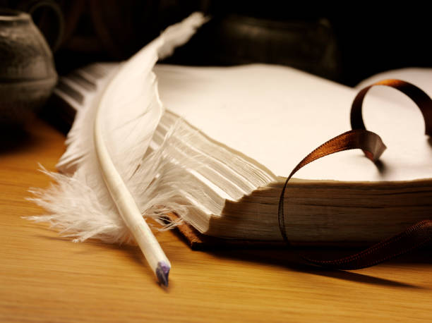 istock Old book and a Feather Quill Pen 480955279