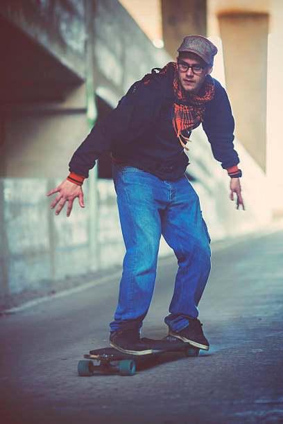 istock Young man longboard skating on the street 480955349