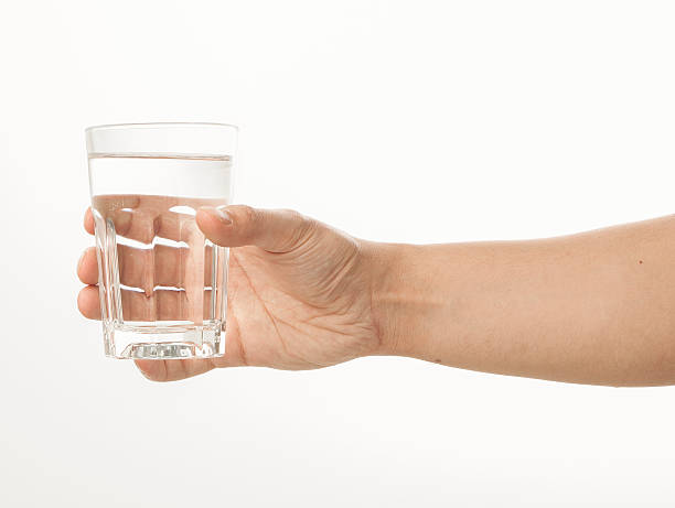 istock Hand holding a glass of water 480957700