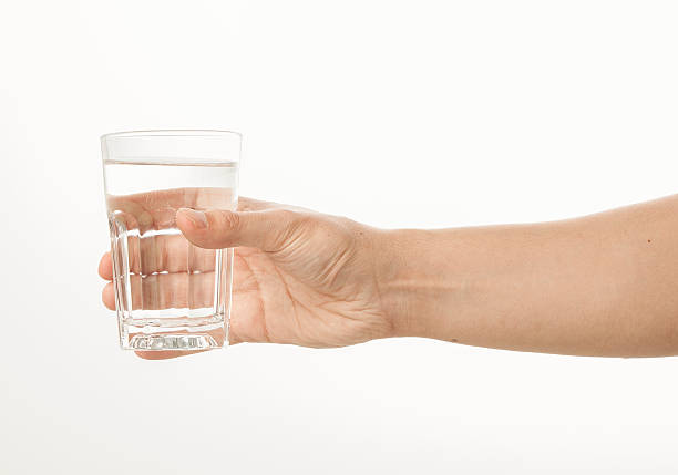 istock Hand holding a glass of water 480957762