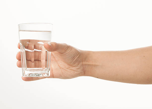istock Hand holding a glass of water 480957766