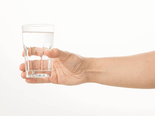 istock Hand holding a glass of water 480957802