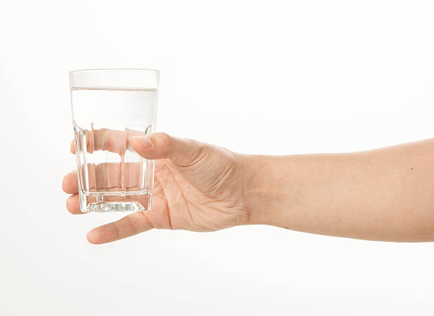 istock Hand holding a glass of water 480957834