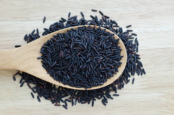 istock Rice berry in a wooden ladle, on wood table. 480963949
