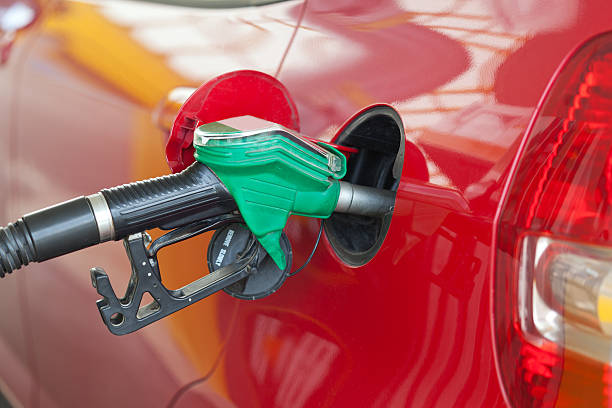 Car being filled with fuel Red car at gas station being filled with fuel ethanol photos stock pictures, royalty-free photos & images