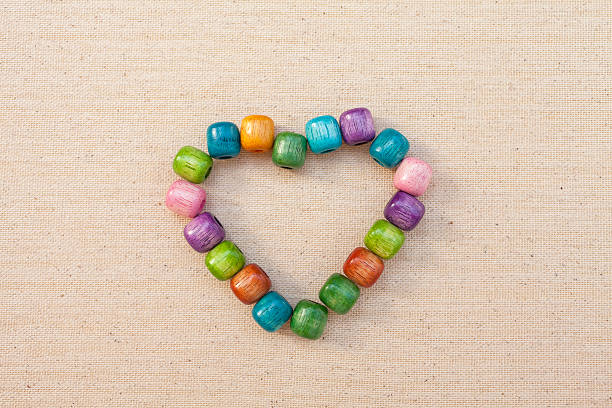 istock Colorful wooden beads heart background 480964856