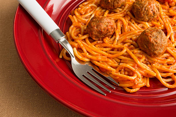 istock Spaghetti and meatballs on a red dish with fork. 480965288