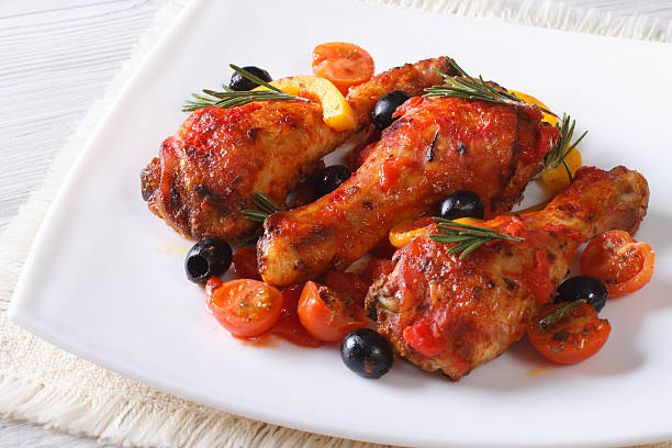 istock Stewed chicken legs in tomato sauce  on a plate, horizontal 480965358