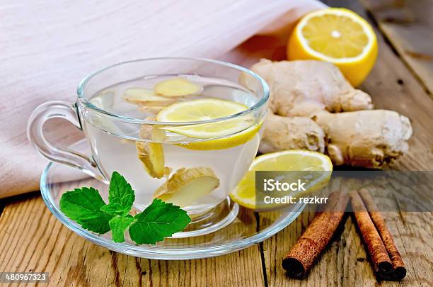 Tea Ginger With Lemon And Cinnamon On Board Stock Photo - Download Image Now - Alternative Therapy, Cinnamon, Citrus Fruit