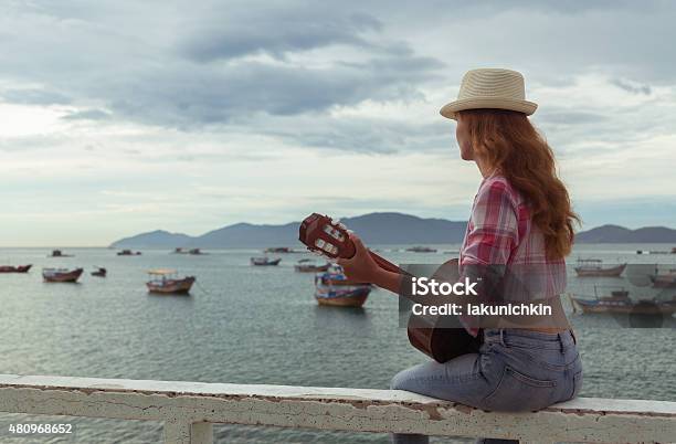 Beautiful Redhaired Girl With A Guitar Stock Photo - Download Image Now - 2015, Adult, Beach