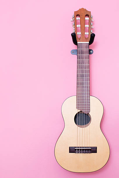 istock guitar hang on the pink wall 480969865