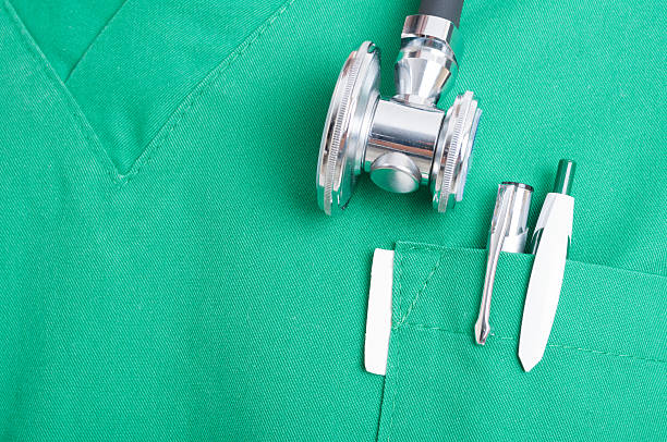 Stethoscope and pen in scrubs pocket stock photo