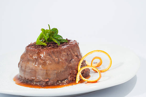 chocolate pudding decorated with mint and orange peel stock photo