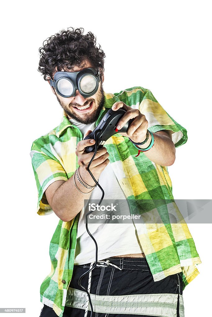 Gamer a guy wearing casual clothes and on old pair of goggles over a white bachground and using a gamepad controller Humor Stock Photo