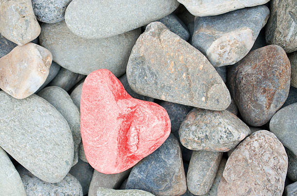 heart shaped stone painted red stock photo