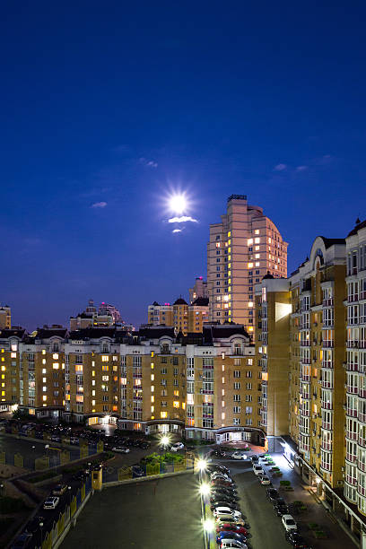 istock Moon in the night sky over city. 480977238