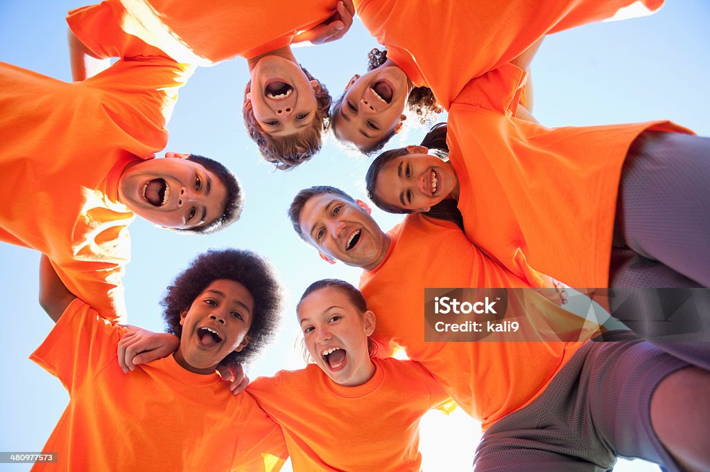 Coach with group of children Coach (20s) with multi-ethnic group of children (9 to 11 years). Summer Camp Stock Photo