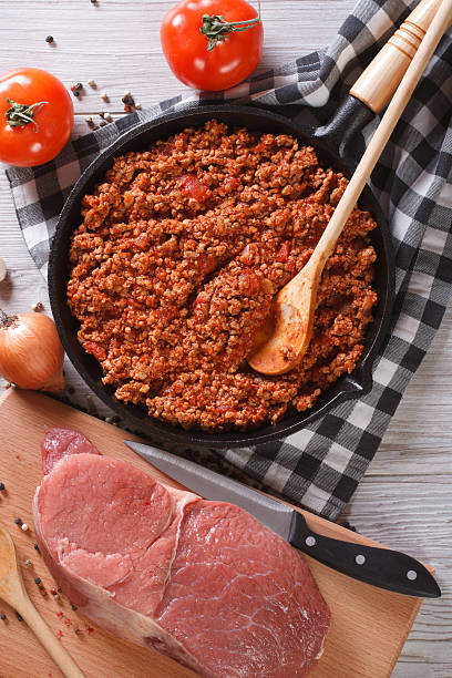 istock Bolognese sauce in skillet with ingredients vertical top view 480981030