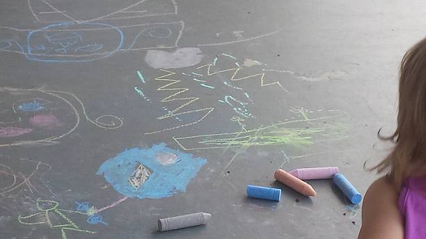 istock Toddler Girl with Sidewalk Chalk 480981120