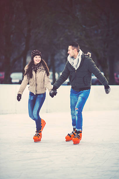 istock Young couple ice skating outdoors 480982911