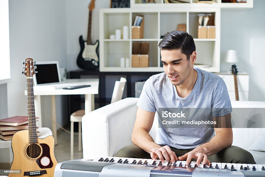 Musician Young musician writing songs at studio Piano Stock Photo